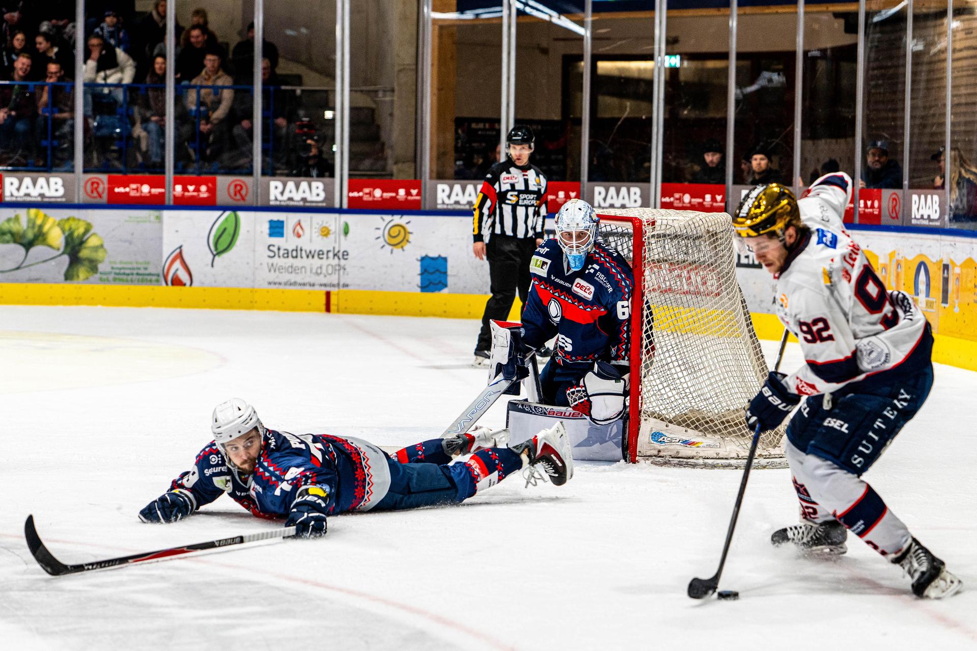 Calvin Pokorny (liegend) mit vollem Einsatz gegen den Ravensburger Goldhelm Mark Rassel. Die Blue Devils Weiden verloren ihr Heimspiel gegen die Towerstars am Sonntagabend mit 0:2.  (Bild: Elke Englmaier)
